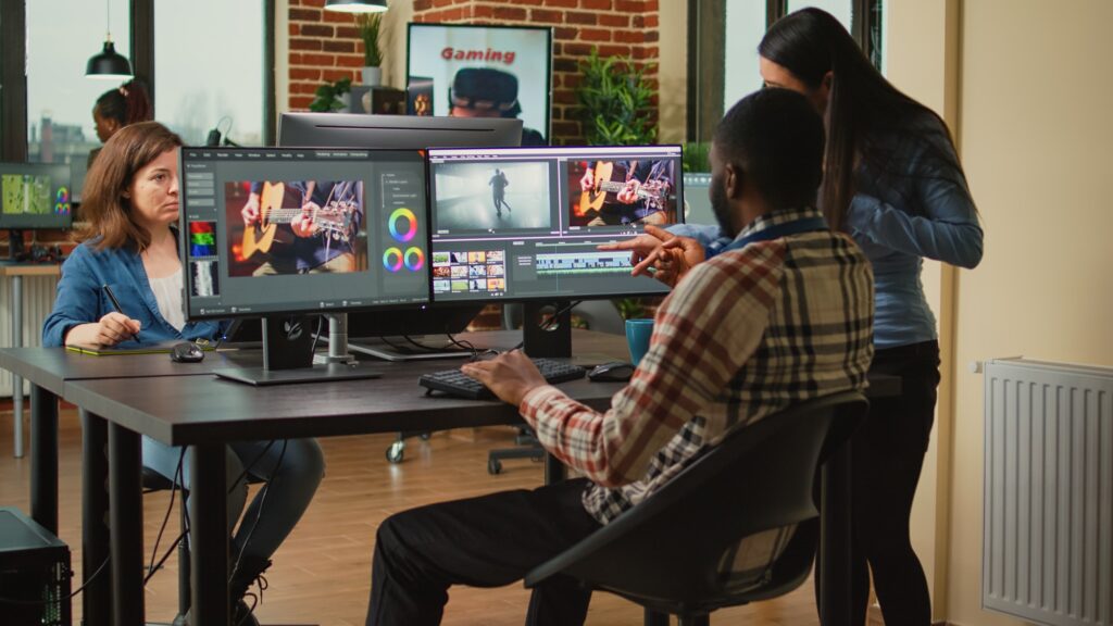 Team of artistic content creators editing movie montage on software